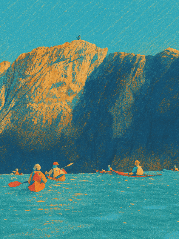 Kayakers paddling near a tall seaside cliff