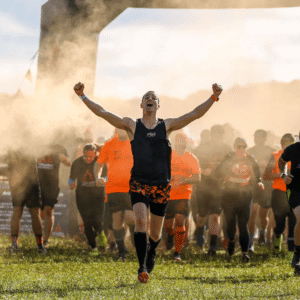Runner celebrating at outdoor race finish line