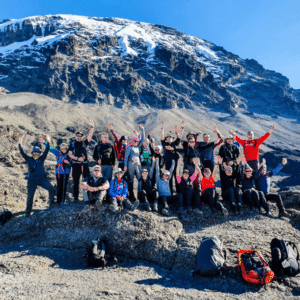 Group of hikers celebrating on a mountain trail