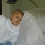 Ill child resting in hospital bed