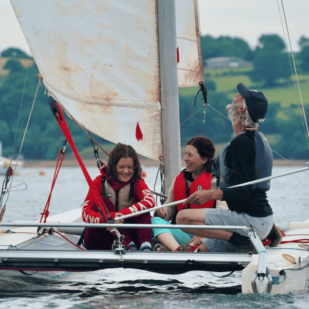 3 Young people in boat sailing